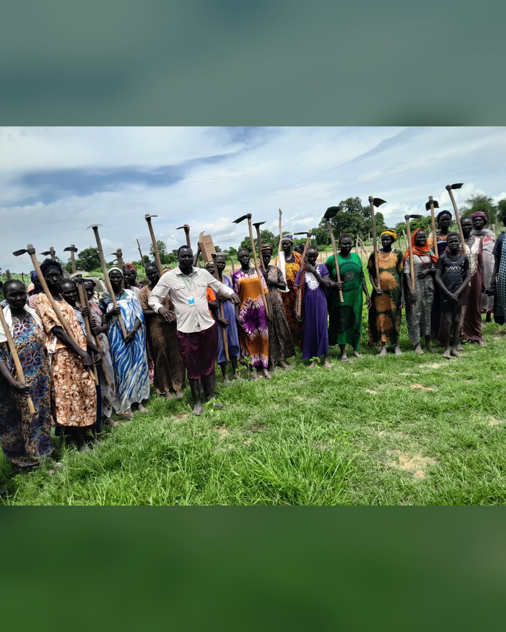 A woman farmer tending crops in a green field in South Sudan